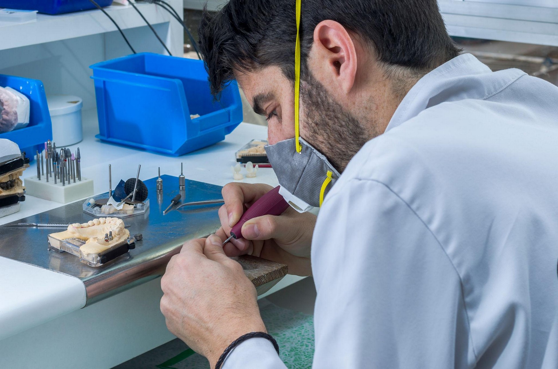 Dental technician crafting a custom crown as part of dental lab services in California.