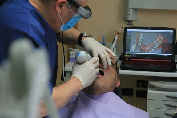 Dentist performing analog to digital dental in California with a 3D scanner