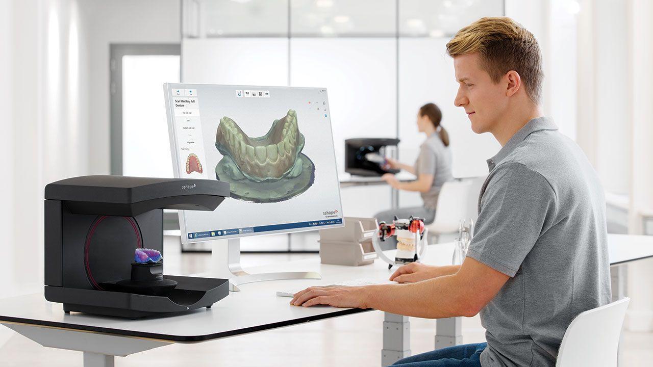 Dental laboratory technician scanning physical dental models for dental file conversion in Atwater