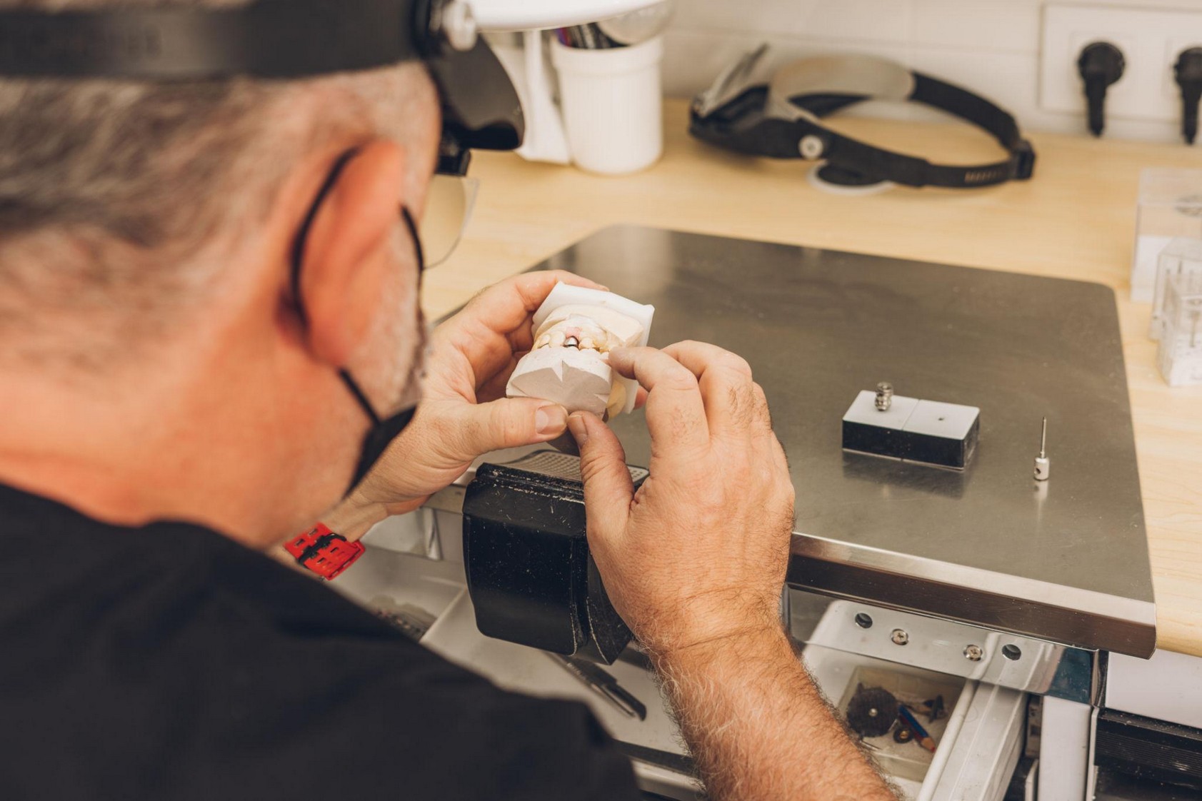 Dental technician working on dental prosthesis in California in a professional laboratory.