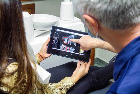 Patient reviewing premium dental prosthesis in California on a digital scan