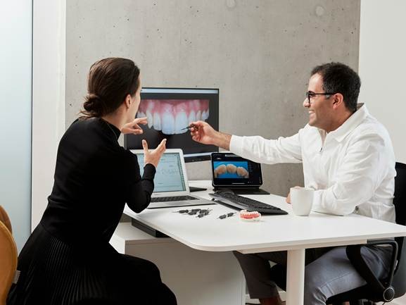 Dentist explaining treatment at a digital dental lab in California