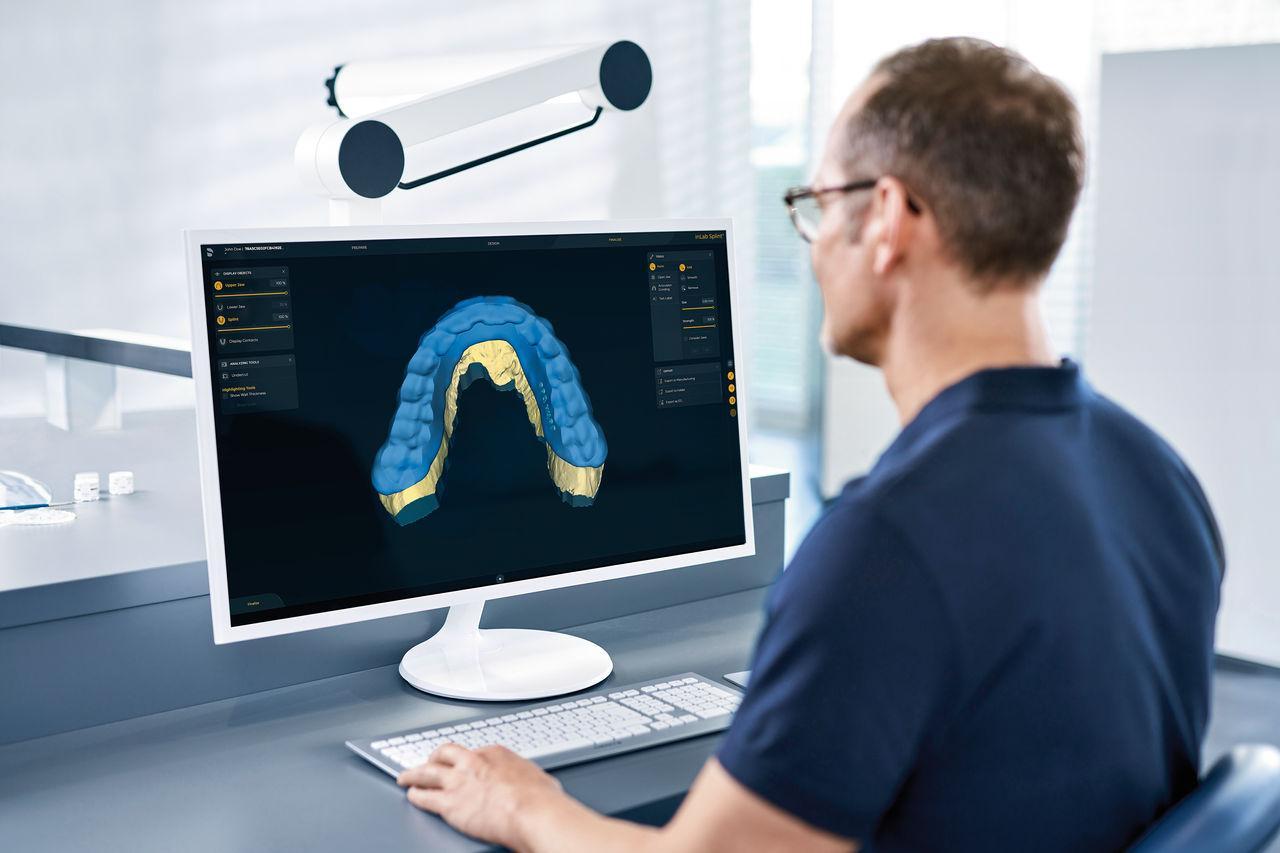 Dental technician reviewing a 3D model for digital dental conversion in Atwater