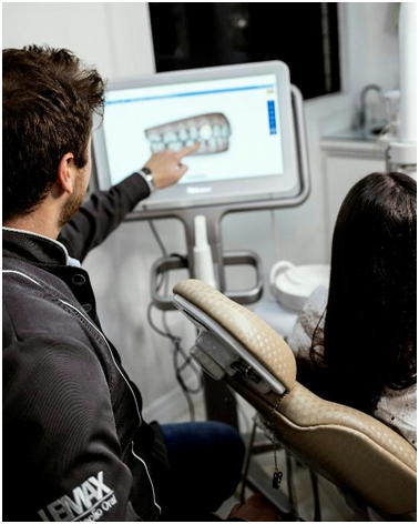 Dentist reviewing a digital intraoral scan with a patient in California